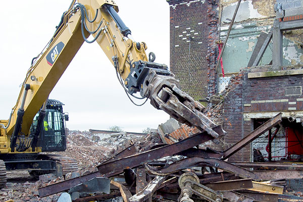 Cat heavy equipment demolishing building